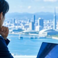 福岡の店舗や施設が生成AI回答に引用されるための情報発信を示すパソコン画面と福岡の街並み